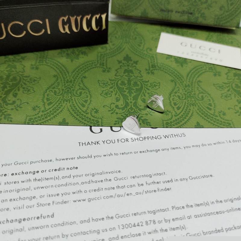 G*u*i earrings